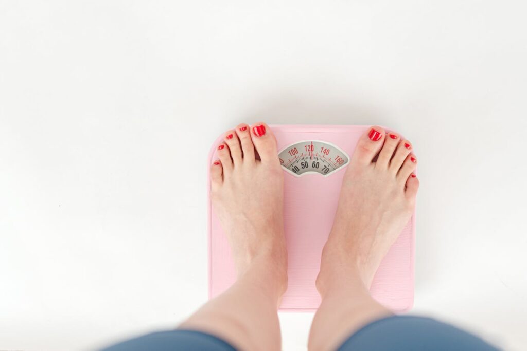 pexels-photo-6975474-6975474.jpg
womens feet with red nail varnish on a pink scale.